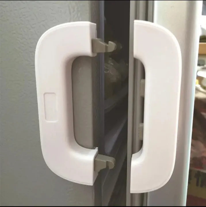 White refrigerator safety lock shown open on fridge door
