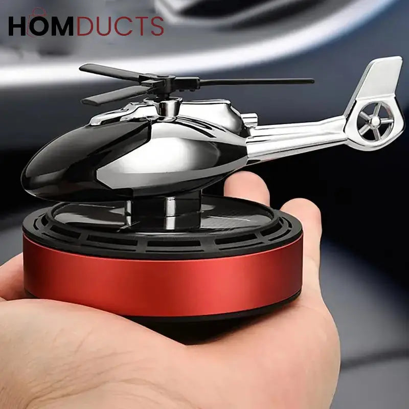 Solar powered helicopter car fragrance diffuser on dashboard